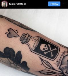 a man's arm with a bottle and skull on it