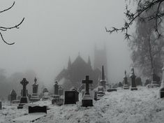 a cemetery with many headstones in the snow