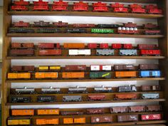 there are many different types of toy trains on display in the store's shelves