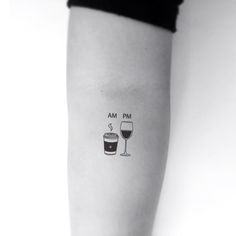 a woman's arm with a wine glass and cup tattoo on the left forearm