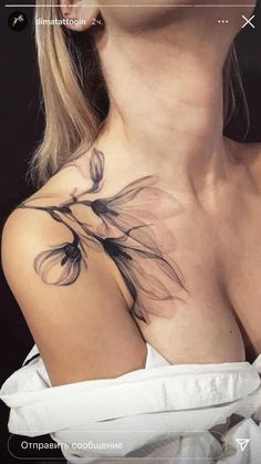 a woman with a flower tattoo on her chest