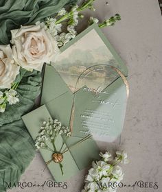 wedding stationery with white flowers and greenery