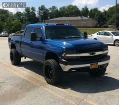 a blue truck parked in a parking lot