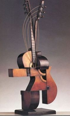 an abstract sculpture with guitar heads and strings