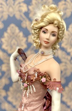 a barbie doll wearing a pink dress and pearls