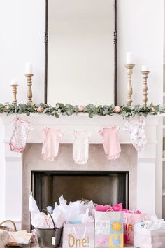 Girl Baby Shower Onesie Mantle Decor Pink Girly Baby Shower Ideas, Winter Pink Baby Shower Ideas, Baby Shower Fireplace Mantle, Pink And White Baby Shower Ideas, Baby Onesie Garland, Pink Baby Shower Winter, Love Shack Fancy Baby Shower Theme