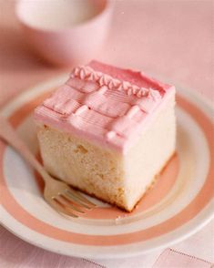 a piece of cake sitting on top of a white and pink plate next to a fork