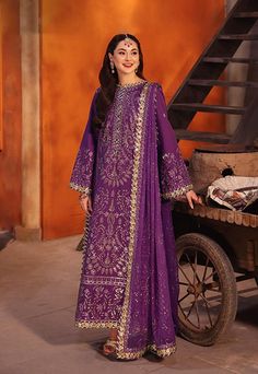 By Pcs: 3 Pcs Shirt: Twisted silk Trouser: Twisted silk Dupatta: Chiffon Color: Purple Product Details Let this purple outfit, with hints of aster's glamour, exude an aura of timeless allure. The meticulously embroidered shirt, a masterpiece in itself, features duo-toned mink and pink zari like stardust woven into the fabric. Light gold cupped sequins, sprinkled like dews on fallen aster petals, catch the light and whisper of forgotten wishes. A meticulously embroidered dupatta, a dreamlike casc Purple Salwar Kameez, Indian Dress Wedding, Dress Party Wear, Asim Jofa, Party Wear Dress, Unstitched Dress Material, Pakistani Salwar Kameez, Purple Outfits, Dress Indian