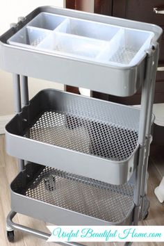 three trays are stacked on top of each other in this kitchen cart with wheels