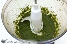 a blender filled with green liquid on top of a counter