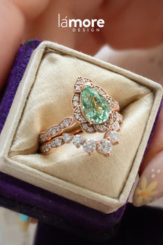 This strikingly gorgeous and unique green sapphire ring bridal set features a large pear-shaped captivating seafoam green sapphire center set gracefully in our signature vintage floral diamond pear ring stacking beautifully with a large 7 diamond U shaped wedding band to create the distinctive and elegant look. Adore your future bride with this vintage style sapphire and diamond ring stack. Diamond Ring Stack, Shaped Wedding Band, Sapphire Diamond Engagement Ring, Diamond Sapphire Engagement Ring, Sapphire Diamond Engagement, Green Sapphire Ring, Pear Ring, Gold Diamond Engagement Rings