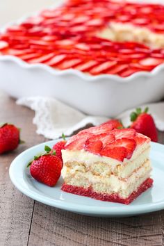 a piece of strawberry cheesecake on a plate with strawberries next to the pie