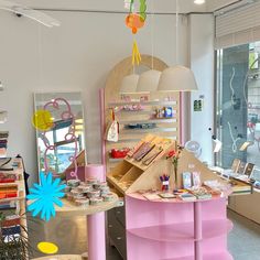 a room with many items on the table and in front of it is a pink counter