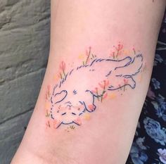 a woman's arm with a rabbit tattoo on the left side of her body