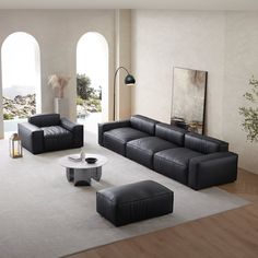 a modern living room with black leather furniture