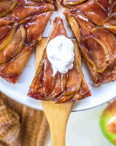 slices of apple pie on a plate with whipped cream