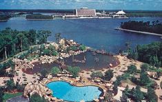 an aerial view of a resort with a large pool and water park in the background