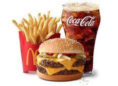 a hamburger, fries and soda are on the table