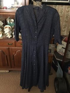 "Vintage 1950's dark Blue sheer Plisse fabric dress. Buttons down the front with Black buttons that have a large Rhinestone in the center. No makers tag. The fabric has no stretch and there is no seam allowances. Has shoulder pads. Since the dress is a SHEER fabric, you may want to wear a full slip underneath. *MORE INFORMATION BELOW* CONDITION: Is missing a belt. One button is missing the Rhinestone. There is a snap at the waist and is missing one side. MEASURES: Bust-36\" Waist-26\" Hips-54\" 1950's Dress, Plisse Fabric, Vintage Clothing Boutique, Dress Buttons, Vintage 1950s Dresses, Blue Sheers, 1950s Dress, Sheer Fabric, Beautiful Hats