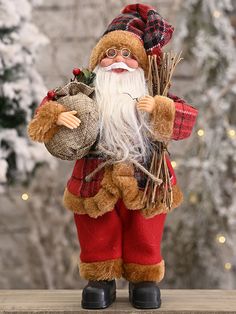 a santa clause doll holding a sack of hay