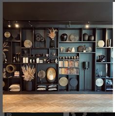 there are many plates on the shelves in this room