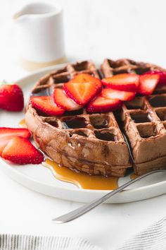 waffles with syrup and strawberries on a plate