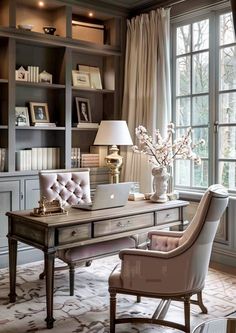 an elegant home office with built - in bookcases, desk and chair by the window