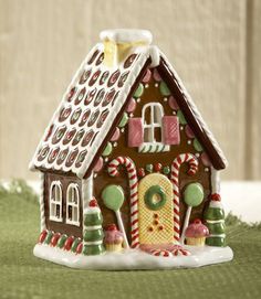 a gingerbread house with candy canes on the roof