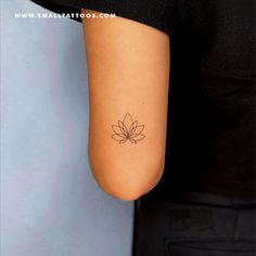 a woman's arm with a small tattoo design on the left side of her arm