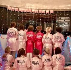 a group of women in pink robes standing next to each other with their names on them