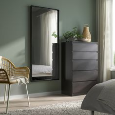 a bedroom scene with focus on the dresser and mirror