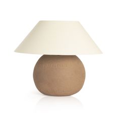 a brown table lamp with a white shade on the top and bottom part of it