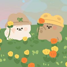 two cats are standing in the grass with flowers