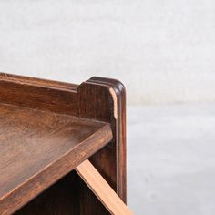 a close up of a wooden table with a shelf on it's side and one section missing