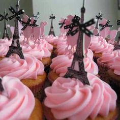 cupcakes with pink frosting in front of the eiffel tower