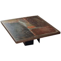 an old table that has been painted with different colors and shapes on it, sitting against a white background