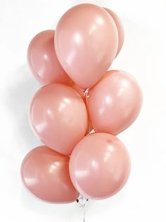 a bunch of pink balloons sitting on top of each other