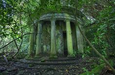 an old stone structure surrounded by trees