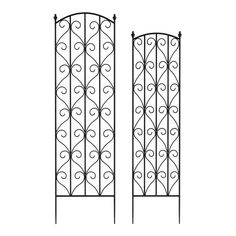 two wrought iron doors with scrolls on them