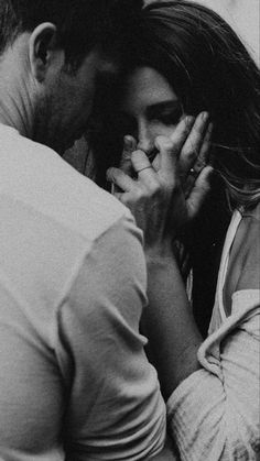 black and white photograph of a man kissing a woman's face with her eyes closed