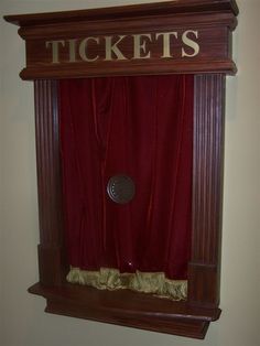 an old fashioned ticket booth with red curtains