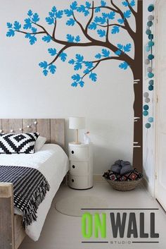 a bedroom with a tree painted on the wall