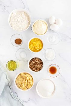 the ingredients to make an oatmeal smoothie laid out on a marble countertop