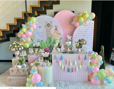 a table filled with lots of colorful balloons and desserts on top of white carpeted flooring