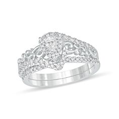 She'll be swept away by the enchanting details of this splendid diamond bridal set. Crafted in cool 10K white gold, the fanciful engagement ring showcases a 1/8 ct. pear-shaped diamond wrapped in a diamond halo. Bypassing diamond-lined ribbons highlight the center while a sculpted filigree design gleams along the shank. On your wedding day, seal your vows with the coordinating diamond-adorned band. Radiant with 5/8 ct. t.w. of diamonds and a brilliant buffed luster, this bridal set shines with a Wedding Bridal Sets In Diamond White With Diamond Accents, Diamond White Bridal Sets With Diamond Accents For Wedding, White Cubic Zirconia Bridal Sets For Marriage, Anniversary Bridal Sets With Intricate Design In Silver, Diamond White Bridal Set For Wedding, Dazzling Silver Bridal Set With Intricate Design, Silver Bridal Sets With Intricate Design In Cubic Zirconia, Silver Dazzling Bridal Set With Intricate Design, White Brilliant Cut Bridal Sets For Wedding