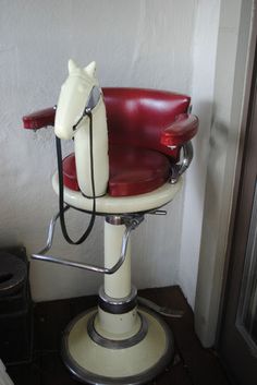 a red and white chair with a horse head on it