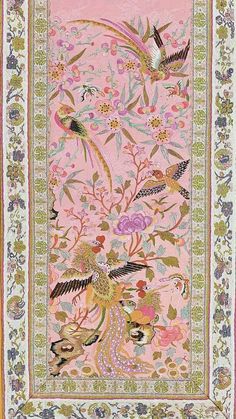 a pink rug with birds and flowers on it