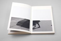 an open book with black and white photos on it's cover, showing the inside pages