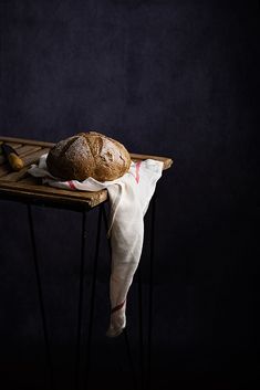 a loaf of bread sitting on top of a wooden table