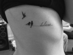 two birds sitting on a wire with the word believe written in cursive font